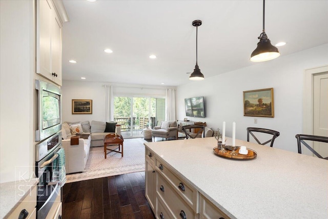859 Orchard Ave SE, East Grand Rapids, MI 49506 - kitchen featuring stainless steel appliances, open floor plan, dark wood-style floors, hanging light fixtures, and recessed lighting