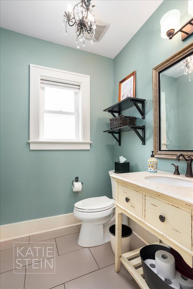 859 Orchard Ave SE, East Grand Rapids, MI 49506 - bathroom featuring tile patterned floors, vanity, and a chandelier