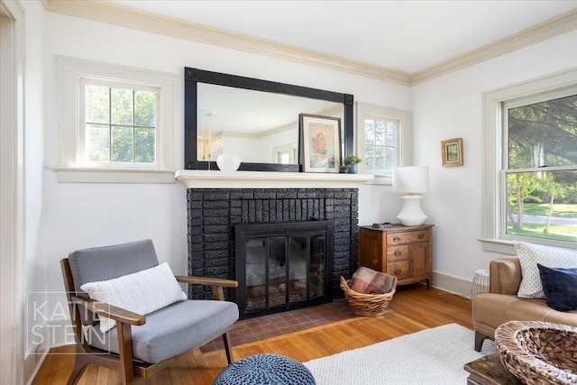 859 Orchard Ave SE, East Grand Rapids, MI 49506 - sitting room with healthy amount of natural light, a brick fireplace, crown molding, and wood finished floors