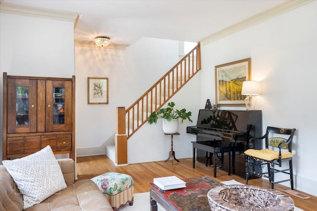 859 Orchard Ave SE, East Grand Rapids, MI 49506 - living area featuring stairway, wood finished floors, and ornamental molding