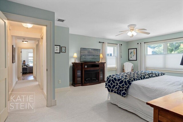 859 Orchard Ave SE, East Grand Rapids, MI 49506 - bedroom with carpet, ceiling fan, and a fireplace