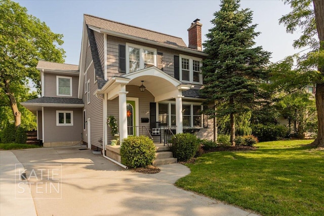 859 Orchard Ave SE, East Grand Rapids, MI 49506 - view of front of property with covered porch, a chimney, and a front yard