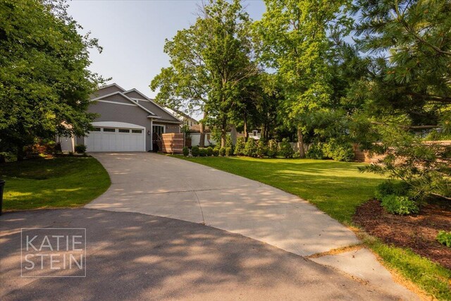 859 Orchard Ave SE, East Grand Rapids, MI 49506 - view of front of home featuring a front lawn, driveway, and an attached garage