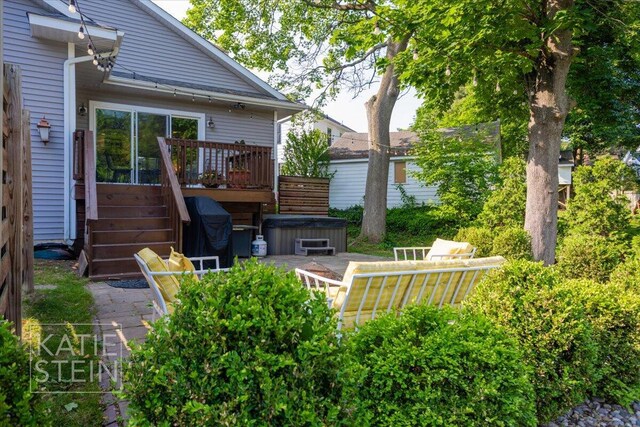 859 Orchard Ave SE, East Grand Rapids, MI 49506 - back of house with a hot tub, a deck, and stairs
