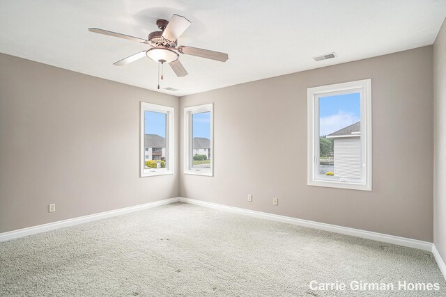 3089 E Crystal Waters Dr Unit 7, Holland, MI 49424 - carpeted empty room featuring plenty of natural light and a ceiling fan