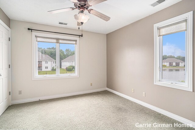 3089 E Crystal Waters Dr Unit 7, Holland, MI 49424 - unfurnished room with ceiling fan and carpet