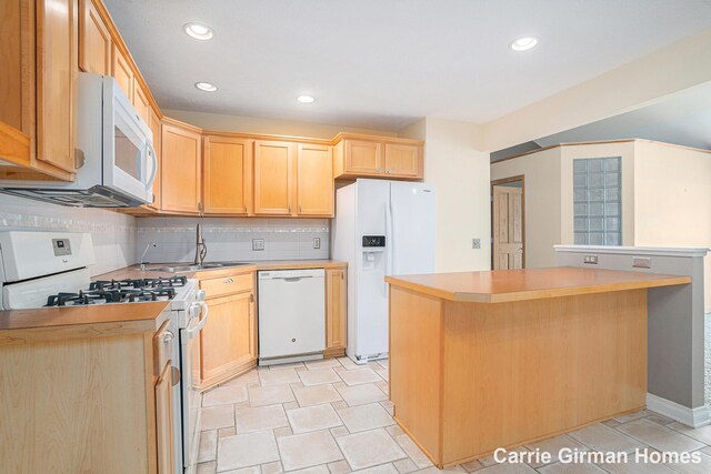 3089 E Crystal Waters Dr Unit 7, Holland, MI 49424 - kitchen with white appliances, light brown cabinets, light countertops, recessed lighting, and backsplash