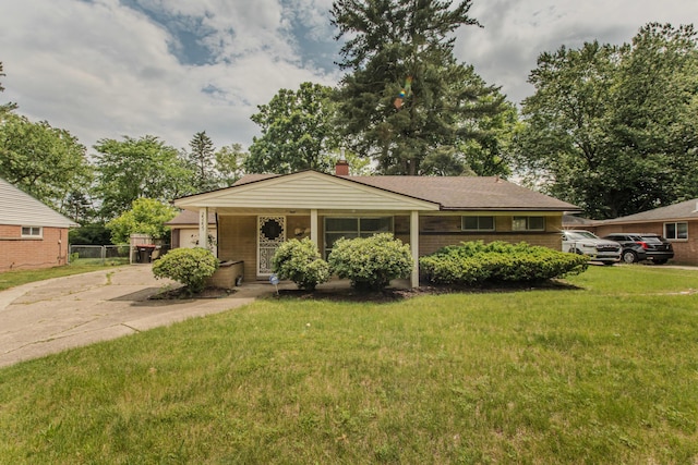 25255 Orchard Grove St, Southfield, MI 48033 - view of front facade featuring concrete driveway, a garage, and a chimney