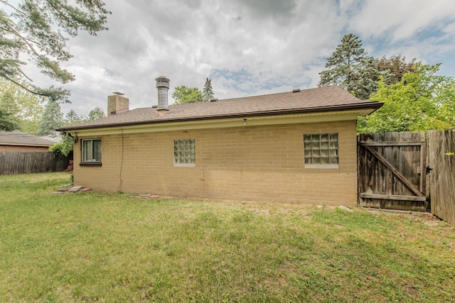 25255 Orchard Grove St, Southfield, MI 48033 - view of side of property with a chimney, brick siding, and a gate