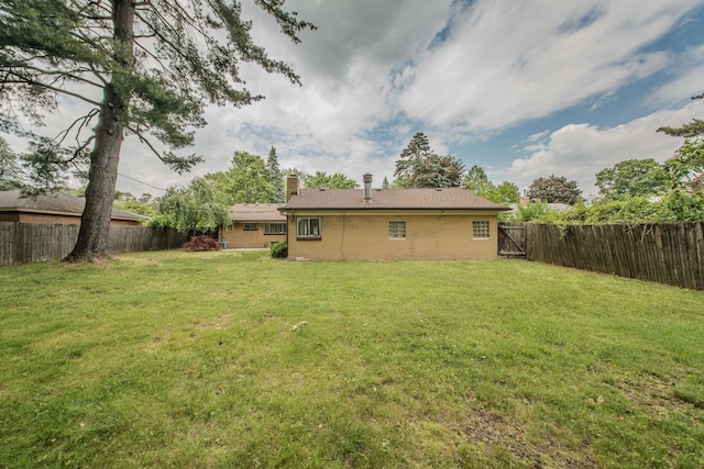 25255 Orchard Grove St, Southfield, MI 48033 - back of property featuring a fenced backyard and a chimney