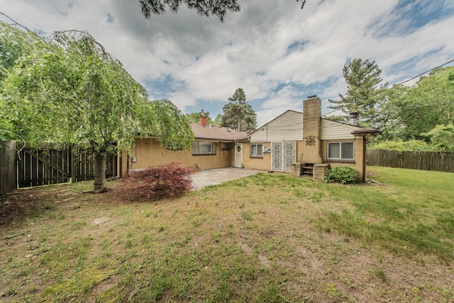 25255 Orchard Grove St, Southfield, MI 48033 - back of property with a chimney, a patio area, and a fenced backyard