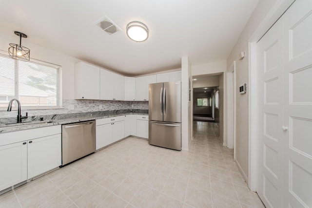 25255 Orchard Grove St, Southfield, MI 48033 - kitchen with appliances with stainless steel finishes, light tile patterned flooring, light stone countertops, white cabinets, and tasteful backsplash