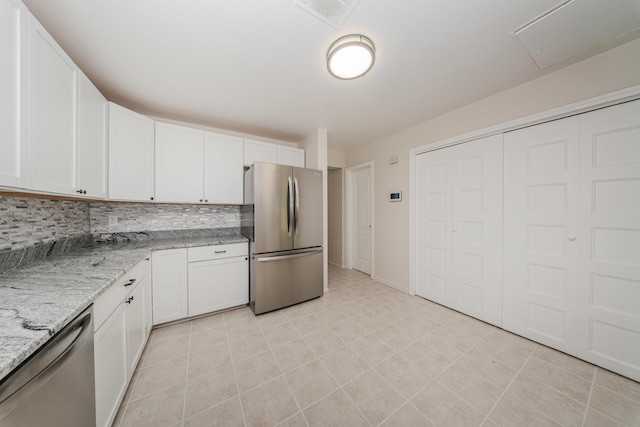 25255 Orchard Grove St, Southfield, MI 48033 - kitchen featuring appliances with stainless steel finishes, tasteful backsplash, and white cabinets