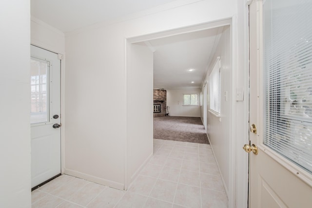25255 Orchard Grove St, Southfield, MI 48033 - foyer entrance featuring crown molding, a fireplace, light tile patterned flooring, and light carpet