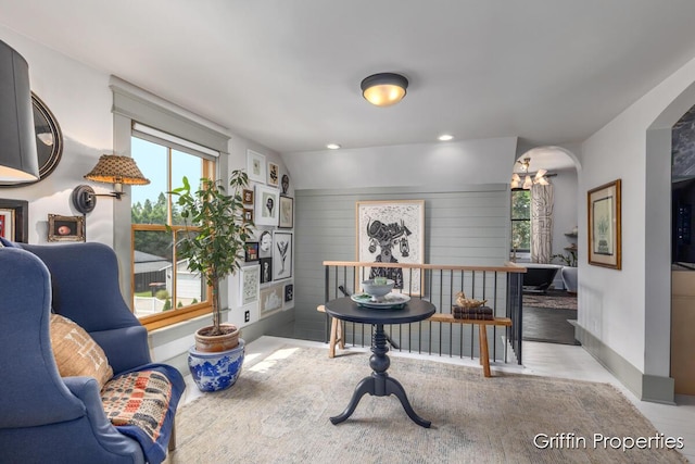 339 W Main Ave, Zeeland, MI 49464 - living area with arched walkways, a chandelier, wood finished floors, and recessed lighting