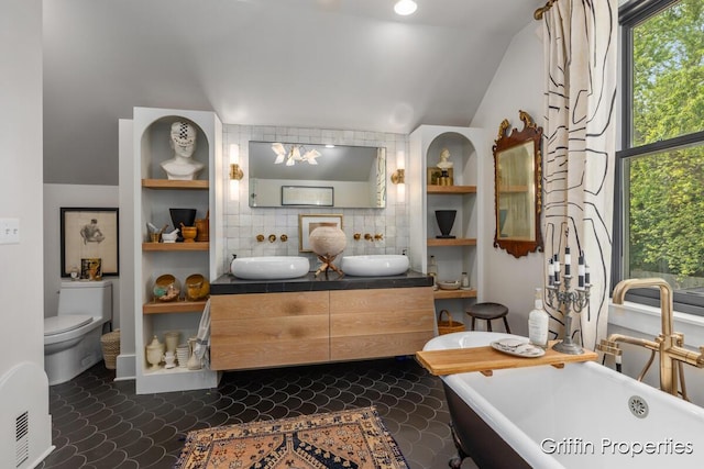 339 W Main Ave, Zeeland, MI 49464 - full bath featuring vaulted ceiling, a soaking tub, double vanity, and decorative backsplash