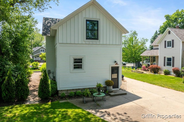 339 W Main Ave, Zeeland, MI 49464 - view of side of property featuring board and batten siding and a yard