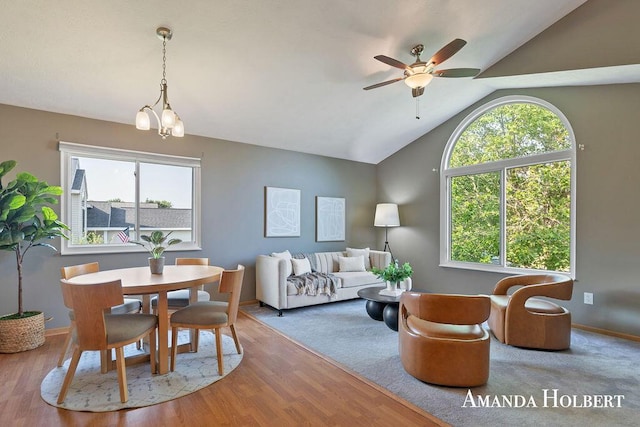 430 6th St NE, Cedar Springs, MI 49319 - living area with a ceiling fan, vaulted ceiling, wood finished floors, and a chandelier