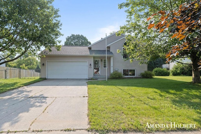 430 6th St NE, Cedar Springs, MI 49319 - tri-level home with an attached garage, concrete driveway, and roof with shingles