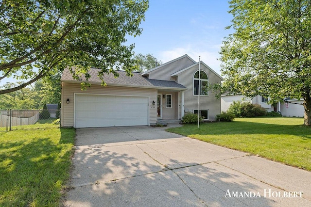 430 6th St NE, Cedar Springs, MI 49319 - split level home with an attached garage and driveway