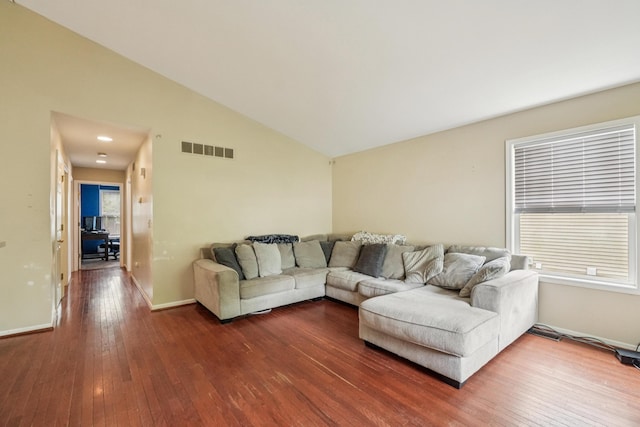 8280 Frederick St, Salem, MI 48175 - living area featuring lofted ceiling, dark wood-style floors, and healthy amount of natural light