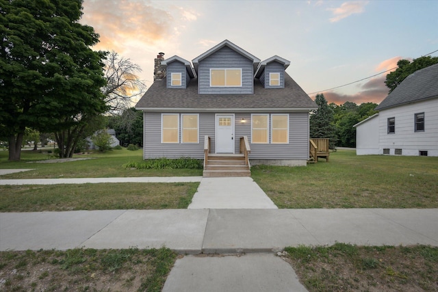 313 E Main St, Marion, MI 49665 - view of front of property featuring a chimney, a lawn, and roof with shingles