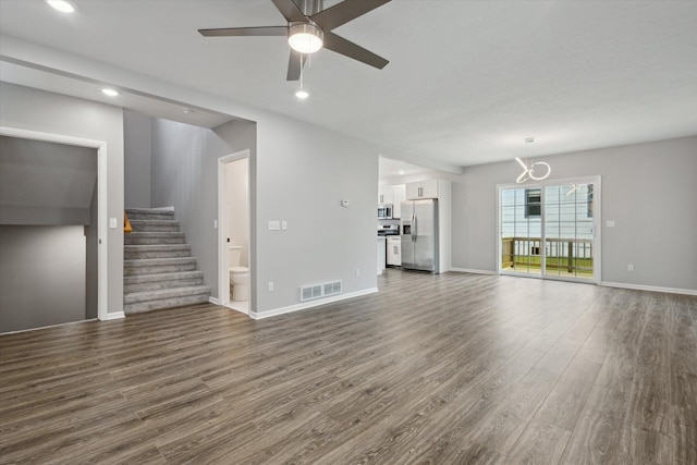 313 E Main St, Marion, MI 49665 - unfurnished living room featuring dark wood-style floors, stairway, recessed lighting, a chandelier, and ceiling fan
