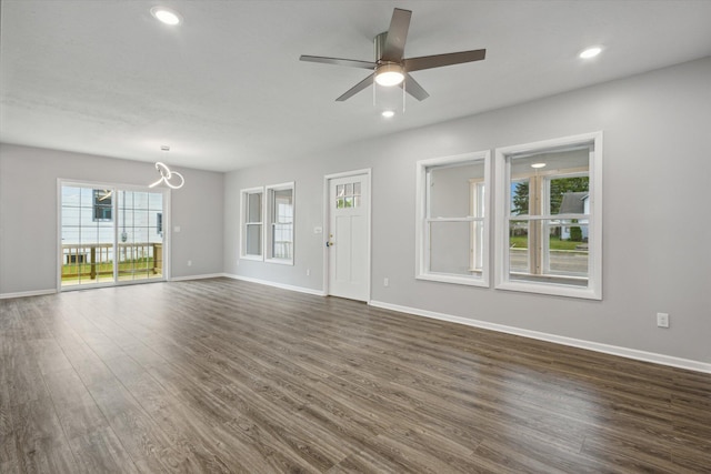313 E Main St, Marion, MI 49665 - unfurnished living room featuring dark wood-style floors, ceiling fan, a chandelier, and recessed lighting