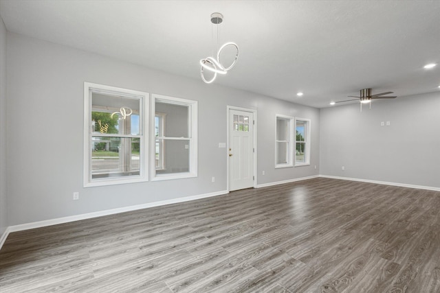 313 E Main St, Marion, MI 49665 - unfurnished living room with wood finished floors, a chandelier, recessed lighting, and ceiling fan