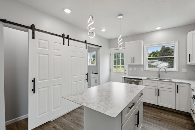 313 E Main St, Marion, MI 49665 - kitchen with a barn door, dark wood-style floors, dishwasher, decorative light fixtures, and a kitchen island