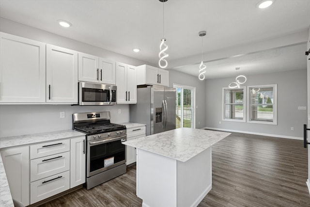 313 E Main St, Marion, MI 49665 - kitchen with appliances with stainless steel finishes, dark wood-style floors, white cabinets, recessed lighting, and a kitchen island