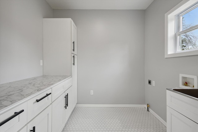 313 E Main St, Marion, MI 49665 - laundry area featuring cabinet space, washer hookup, electric dryer hookup, and light flooring