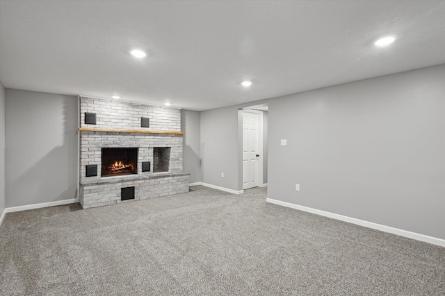 313 E Main St, Marion, MI 49665 - unfurnished living room featuring recessed lighting, a brick fireplace, and carpet floors