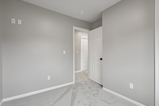 313 E Main St, Marion, MI 49665 - carpeted spare room with baseboards and a smoke detector