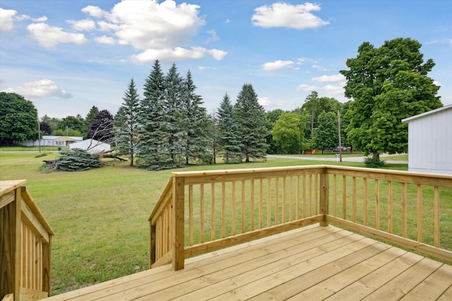 313 E Main St, Marion, MI 49665 - deck featuring a lawn