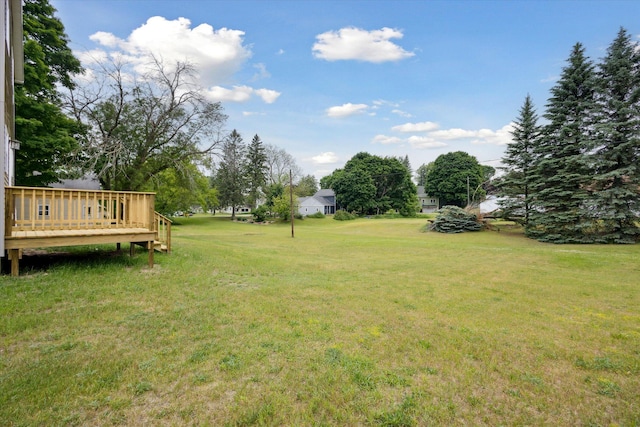 313 E Main St, Marion, MI 49665 - view of green lawn featuring a deck