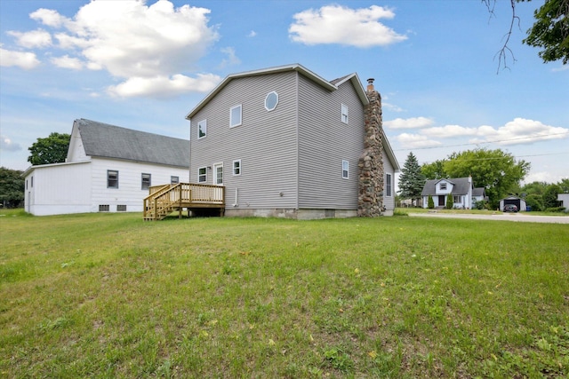 313 E Main St, Marion, MI 49665 - rear view of house with a wooden deck, a yard, and a chimney