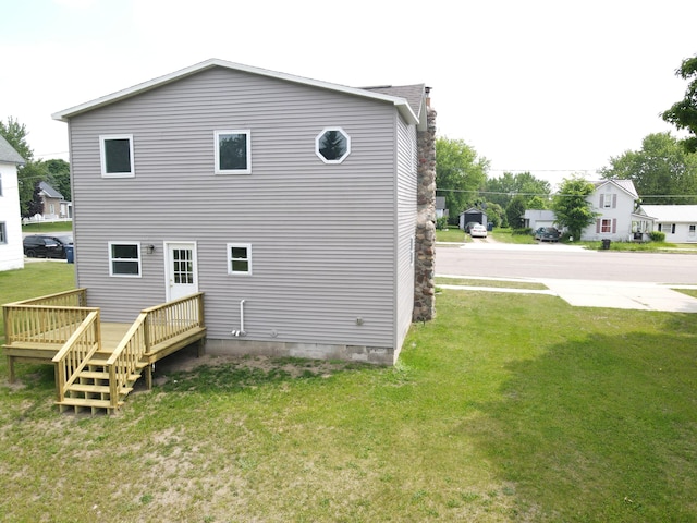 313 E Main St, Marion, MI 49665 - back of house featuring a lawn and a wooden deck