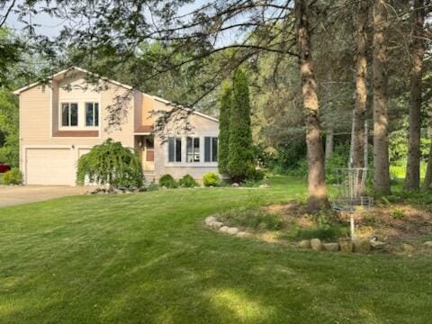 5689 Rothbury Ct, Ypsilanti, MI 48197 - split level home with a garage, driveway, and a front lawn