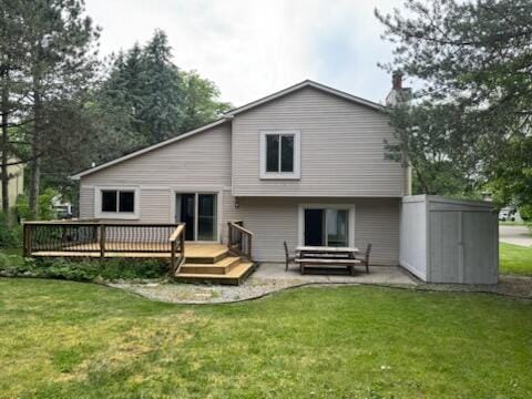 5689 Rothbury Ct, Ypsilanti, MI 48197 - back of house with a wooden deck, a lawn, a patio, and a storage shed