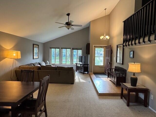 5689 Rothbury Ct, Ypsilanti, MI 48197 - living room featuring a chandelier, high vaulted ceiling, light carpet, and ceiling fan