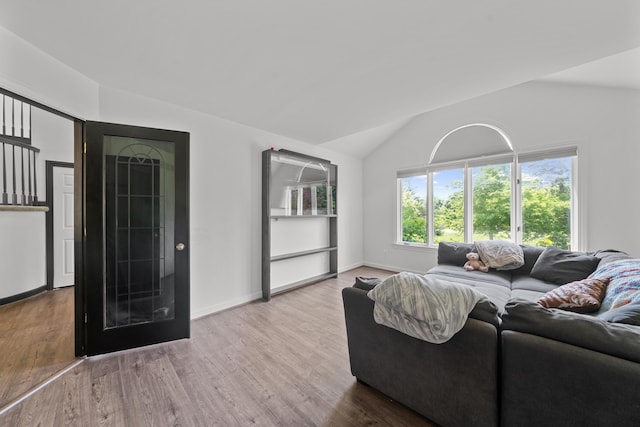 7624 Quail Ridge Dr, Dexter, MI 48130 - living room featuring vaulted ceiling and wood finished floors