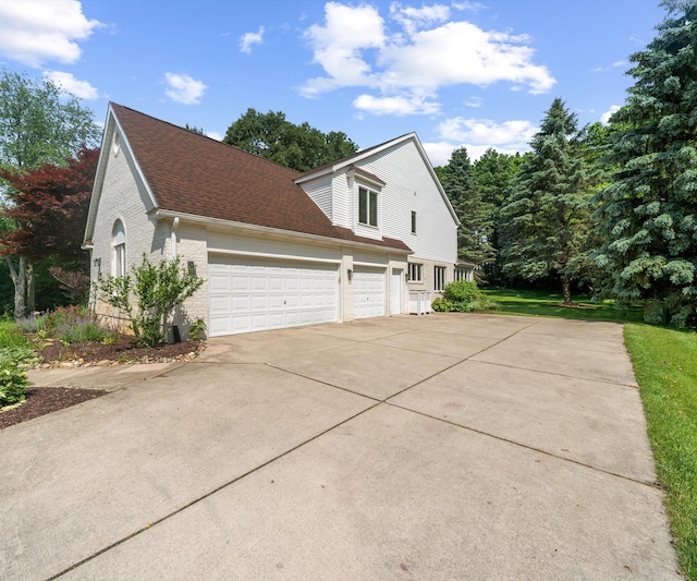 7624 Quail Ridge Dr, Dexter, MI 48130 - view of home's exterior with brick siding, concrete driveway, an attached garage, and a shingled roof