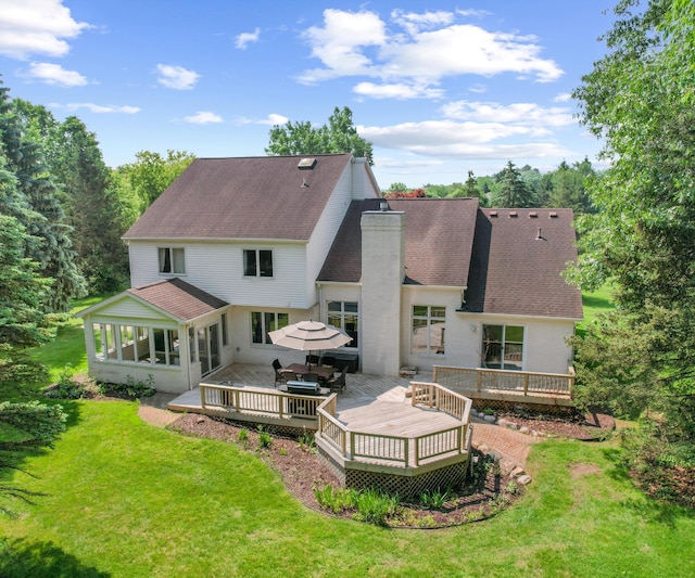 7624 Quail Ridge Dr, Dexter, MI 48130 - rear view of house with a chimney, a lawn, a wooden deck, and a shingled roof