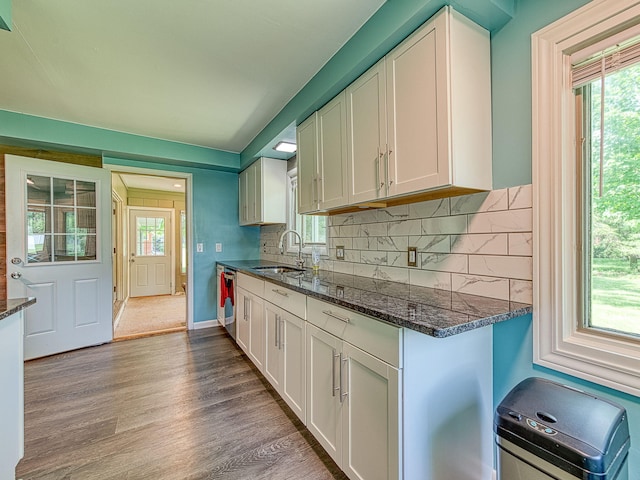 219 Park St, Tecumseh, MI 49286 - kitchen with white cabinets, wood finished floors, backsplash, and dark stone counters