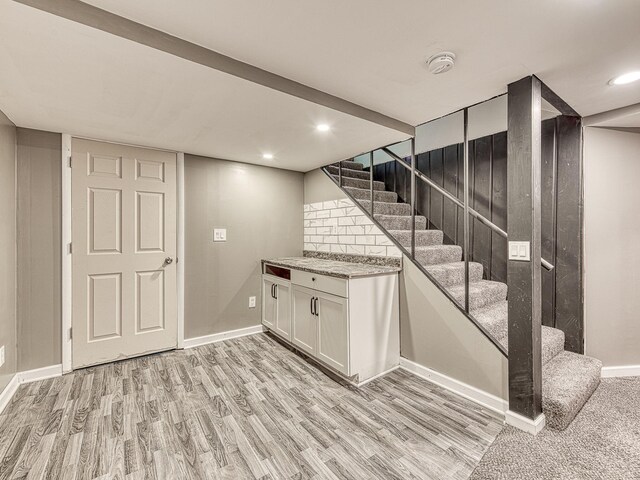 219 Park St, Tecumseh, MI 49286 - finished below grade area featuring stairway, light wood-style floors, and recessed lighting