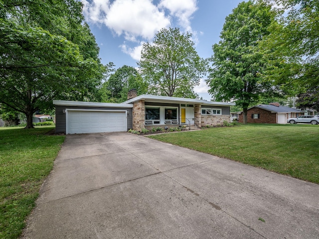 219 Park St, Tecumseh, MI 49286 - mid-century modern home with stone siding, a chimney, a front yard, concrete driveway, and a garage