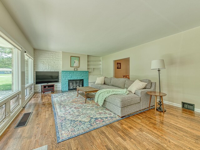 219 Park St, Tecumseh, MI 49286 - living area featuring wood finished floors and a fireplace