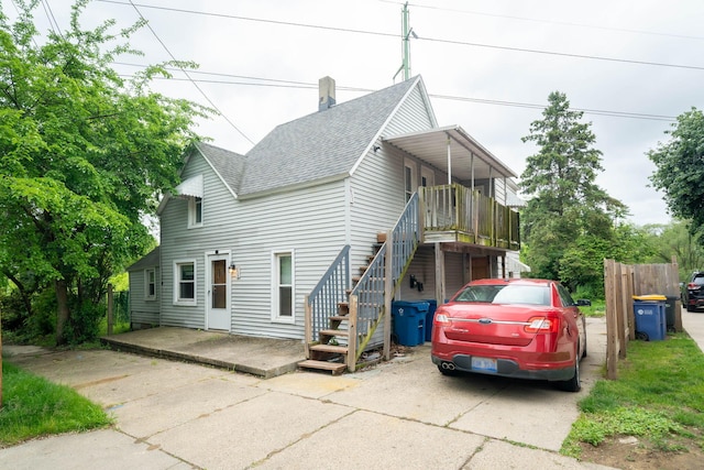 635 Sinclair Ave NE, Grand Rapids, MI 49503 - view of front of house featuring a shingled roof, stairs, and a chimney