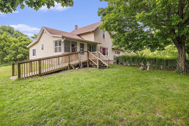 20821 J Dr N, Marshall, MI 49068 - back of property with a sunroom, a wooden deck, a lawn, a chimney, and a shingled roof